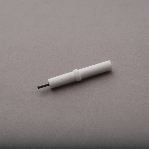 A white plastic pipe on a grey surface.