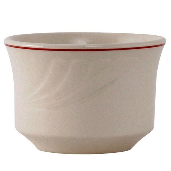 A white Tuxton china bowl with a red rim.