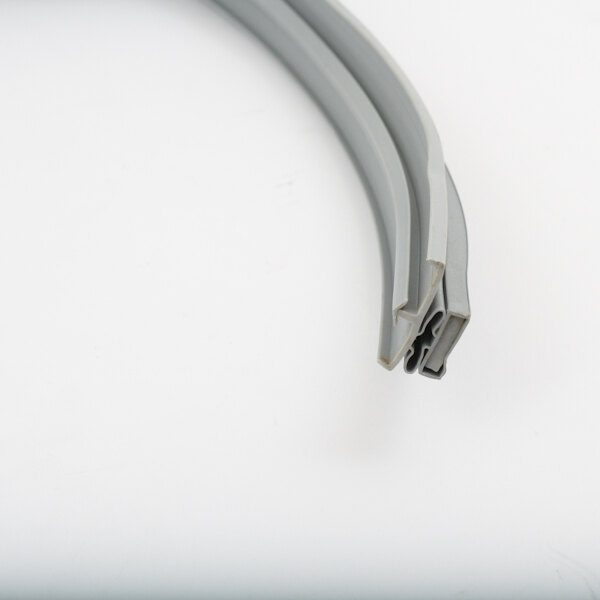 A close-up of a grey plastic strip with a grey plastic ring on the end.