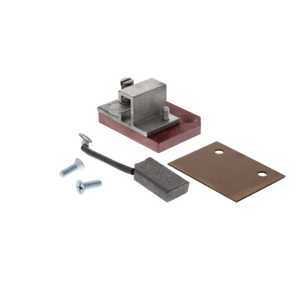 A metal block with a wire and screws, and a brown rectangular object with a hole.