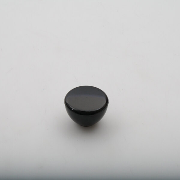 A black Legion knob on a white surface.