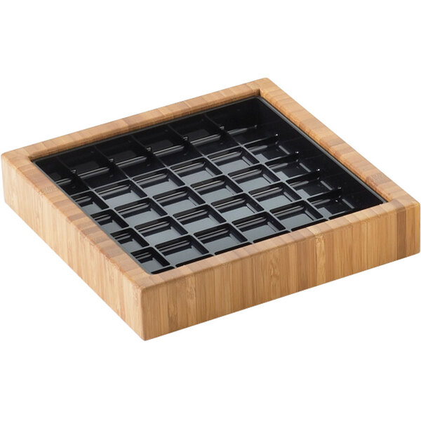 A bamboo square drip tray with black plastic inserts.