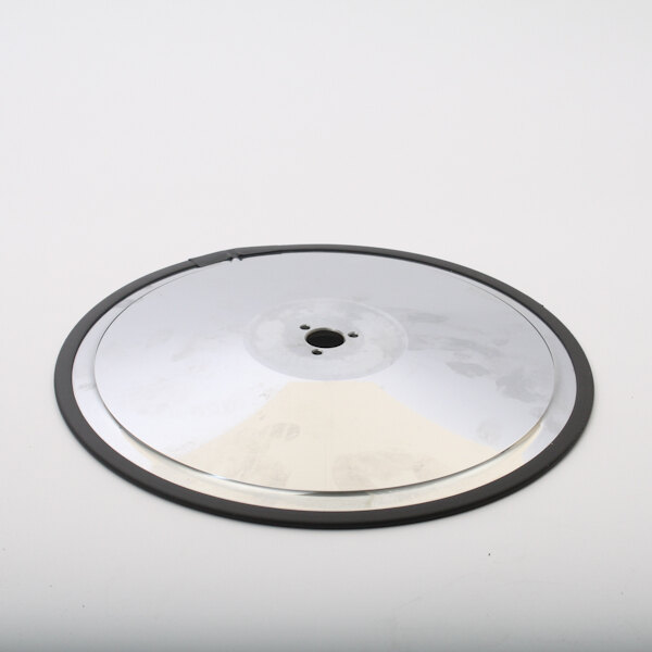 A silver circular disc with a hole in the center.