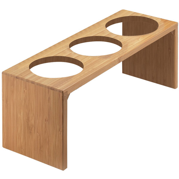 A bamboo stand with three holes in it.
