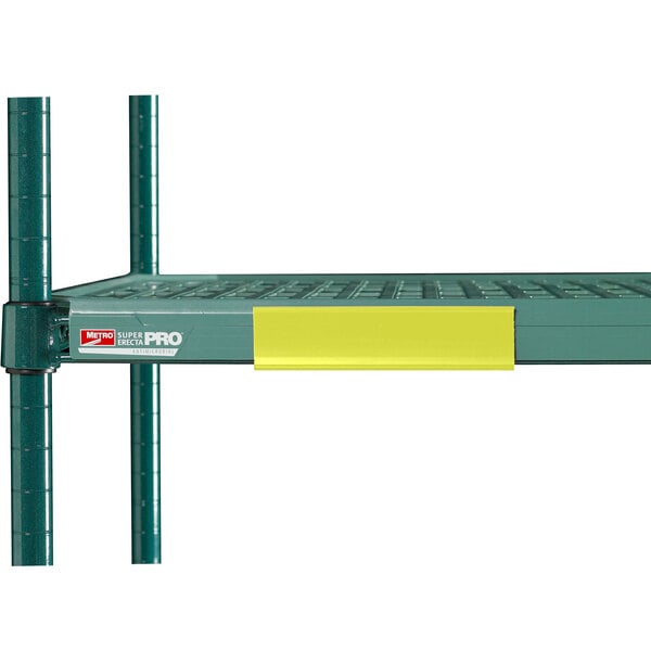 A green metal shelf with yellow Metro shelf markers on it.