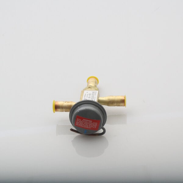 A Master-Bilt head pressure control valve with a yellow handle and red valve.