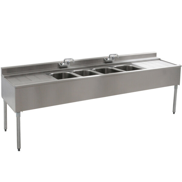 A stainless steel Eagle Group underbar sink with four compartments and two drainboards.