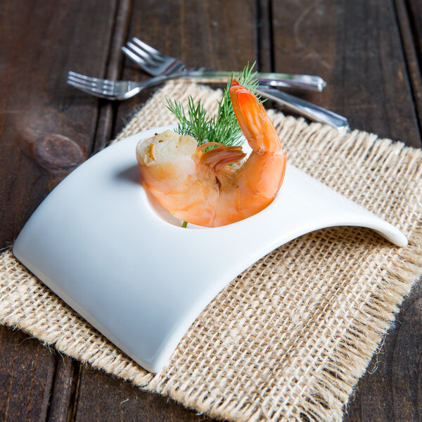 A shrimp on a white Arcoroc rectangular bowl.