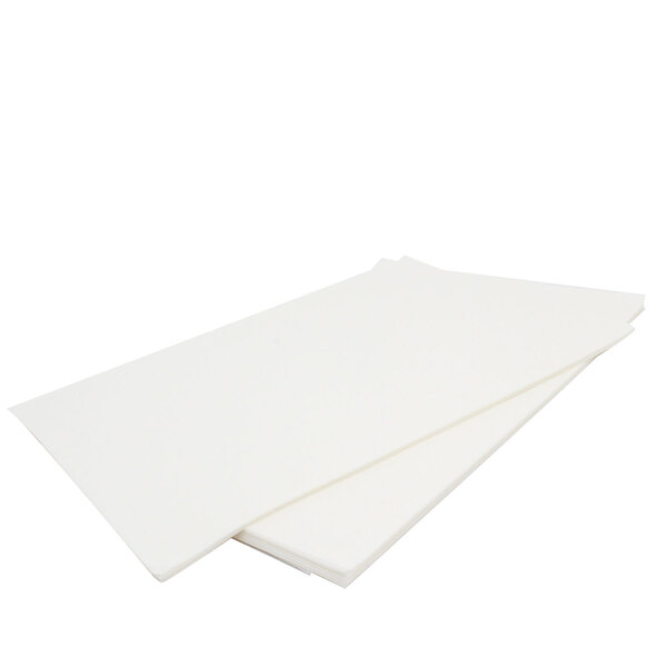 A stack of Keating filter paper on a white surface.