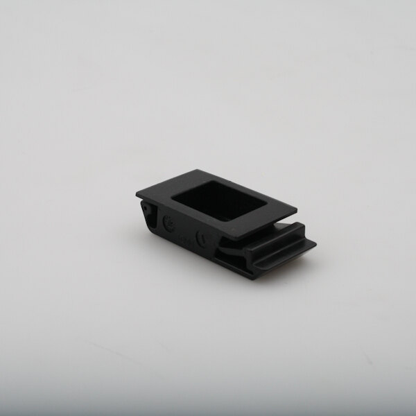 A black rectangular Champion latch with a hole in it on a white surface.
