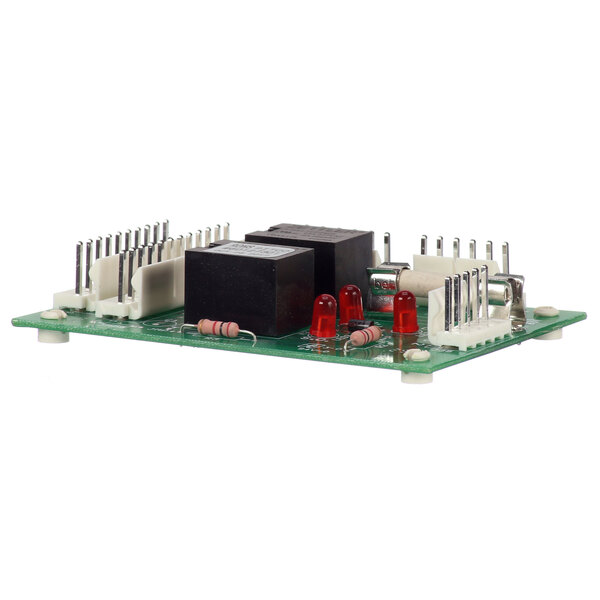 A green circuit board with two black rectangular objects and white labels.