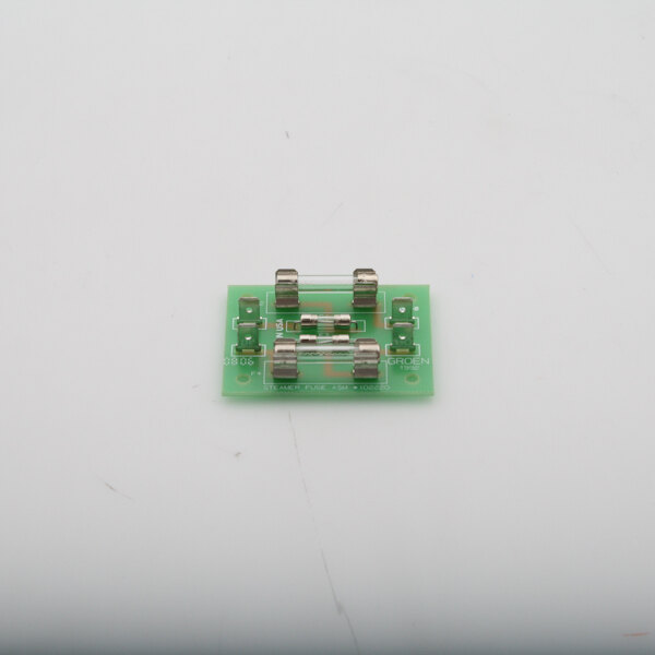 A green Groen circuit board with many small metal parts.