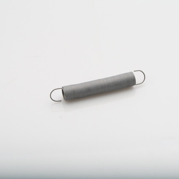 A metal spring from Atlas Metal Industries Inc. on a white surface.