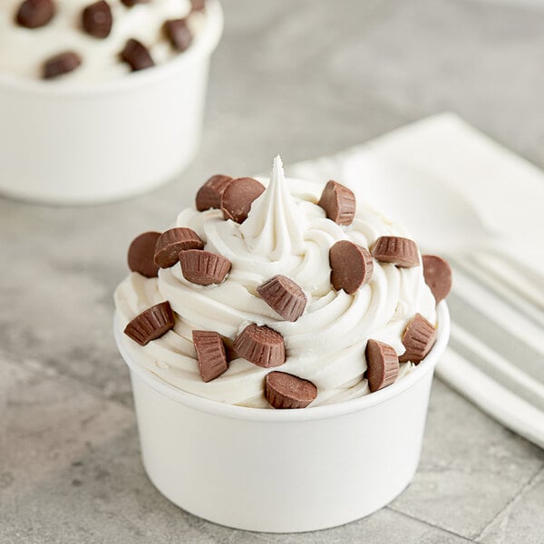 A cup of ice cream with Mini Milk Chocolate Peanut Butter Cups on top.