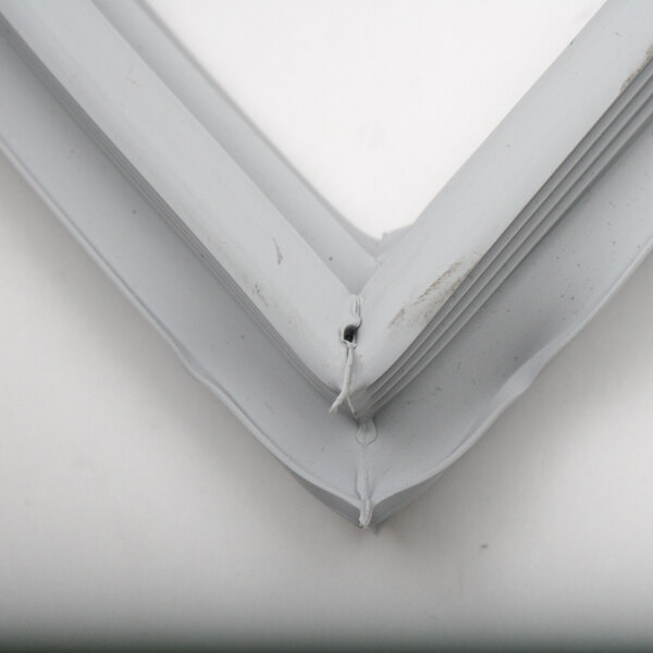 A close-up of a white plastic gasket corner.
