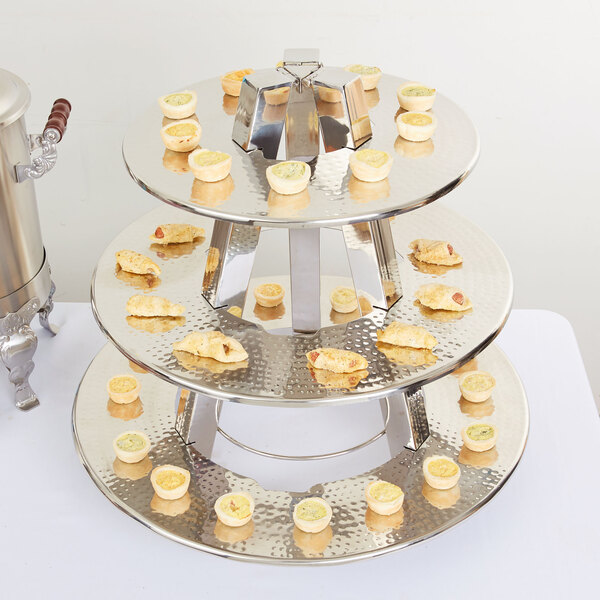 An American Metalcraft three tier display stand holding a tray of food.