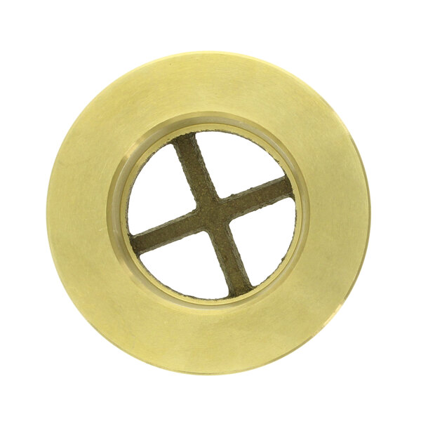 A brass circular disc with four holes and a cross in the center.
