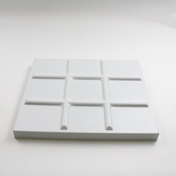 A white rectangular object with a square pattern.