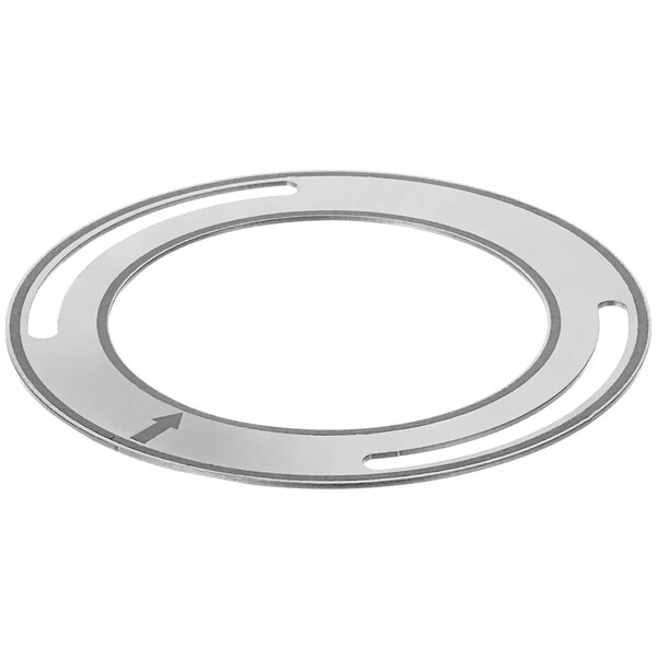 A circular silver metal plate with a circular hole and an arrow.