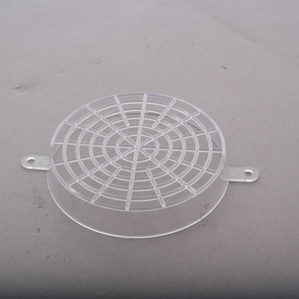 A clear plastic round tray with holes.