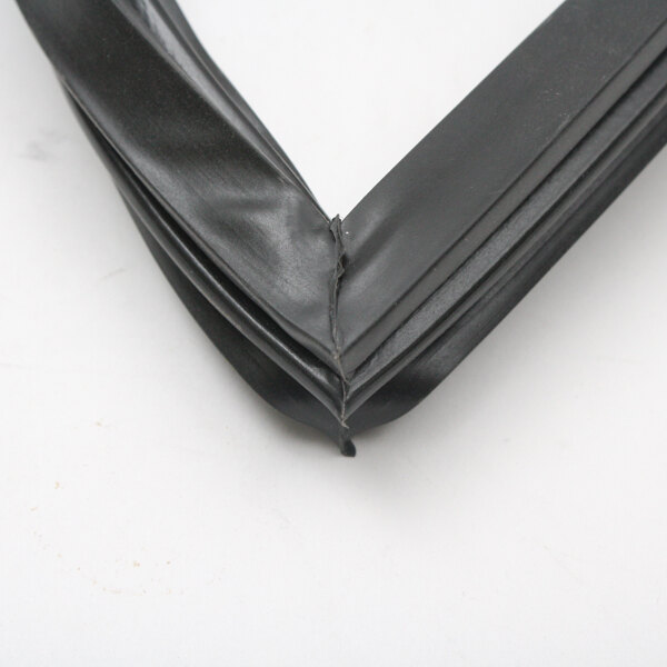 A close-up of a corner of a black rubber seal for a Beverage-Air 703-372CAA.