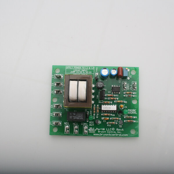A green circuit board with a switch and a button.