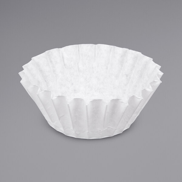 A white paper coffee filter on a gray surface.