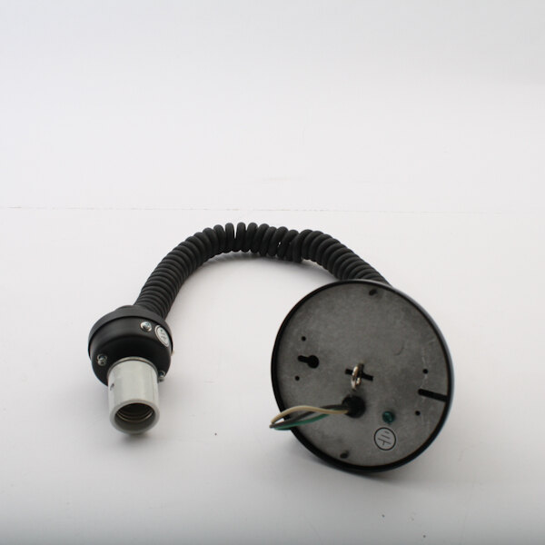 A black and white cable with a black connector on a round object.