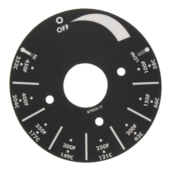 A circular black dial plate with white text and arrows.
