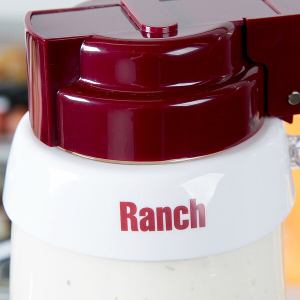A white Tablecraft dispenser collar with maroon "Ranch" lettering.