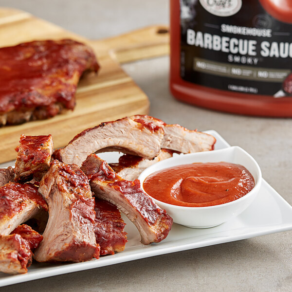 A plate of ribs with Sauce Craft Hickory Smoked BBQ Sauce on it.
