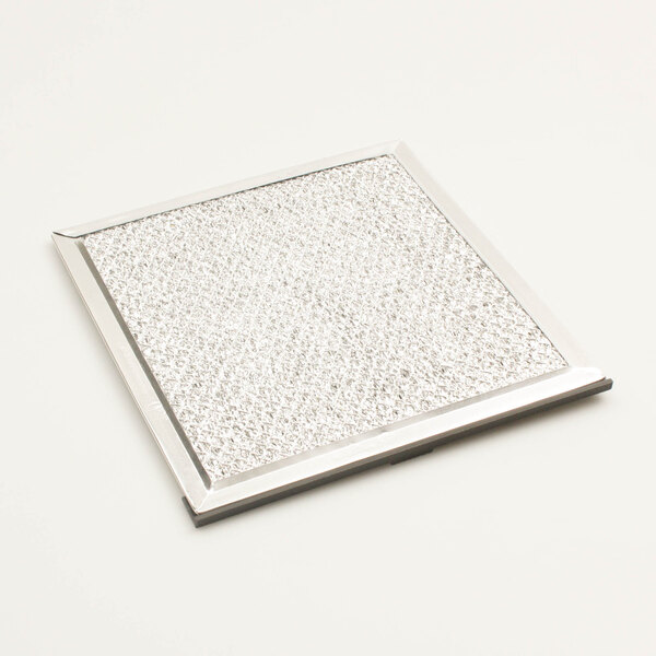 A white square air filter with a silver border.