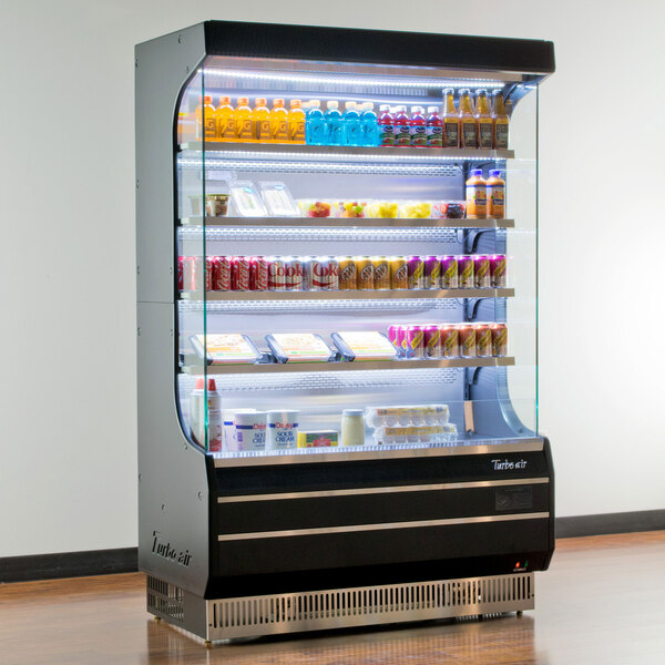 A black Turbo Air air curtain merchandiser with drinks and beverages inside.