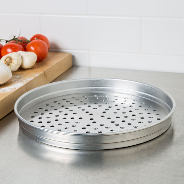 An American Metalcraft aluminum pizza pan with holes on a white background.