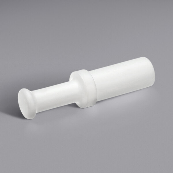 A white plastic food pusher tube.