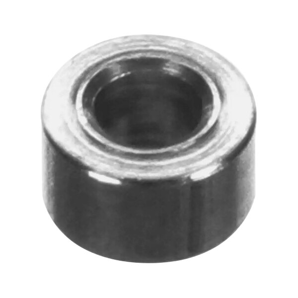 A close-up of a round black metal spacer with a hole.