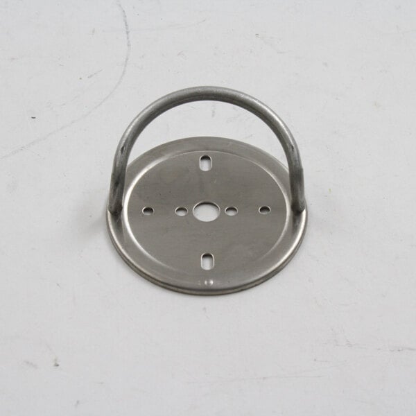 A Wells trim ring, a metal plate with a hole and holes in it.