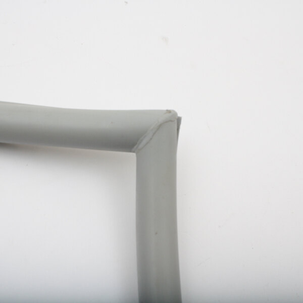 A close-up of a grey plastic tube with a white corner piece.