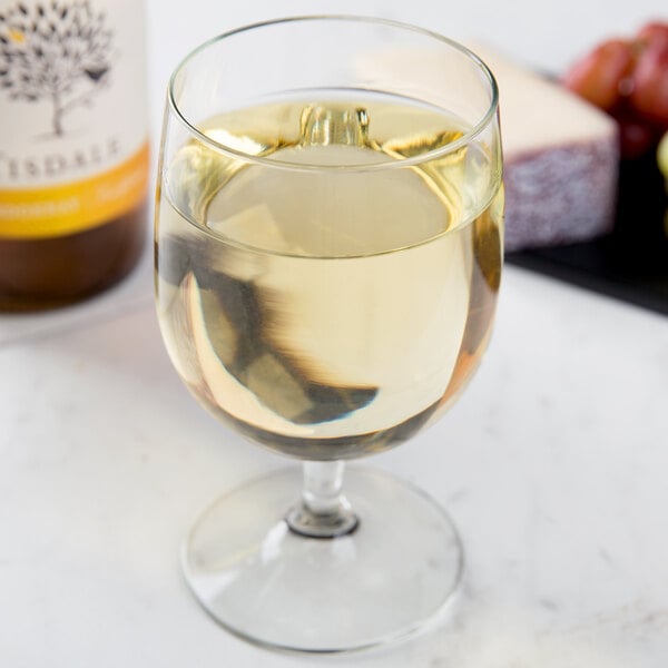 A Libbey Bristol Valley goblet filled with white wine on a white background.