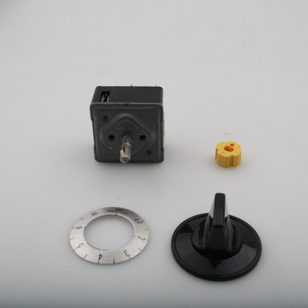A small black square humidistat with a metal knob.