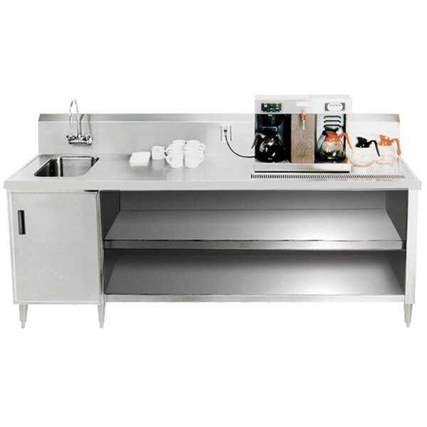 A stainless steel Advance Tabco beverage table with a sink on a white counter.