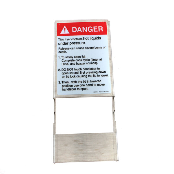 A metal lock lid frame with a warning sign on it.