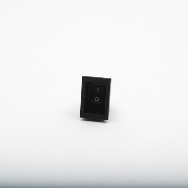 A black rectangular Blodgett switch with a white circle on the center.