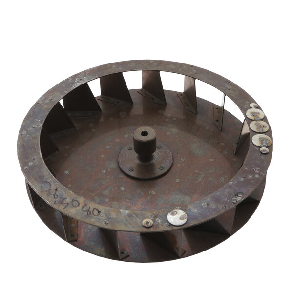 A Groen blower wheel, a metal circular object with holes.