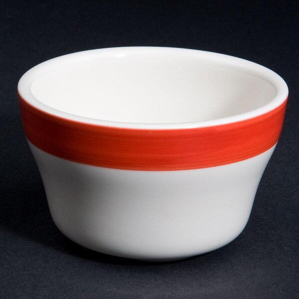 A close up of a white bowl with red stripes.