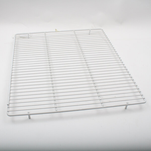 A white metal grid for the bottom shelf of a Master-Bilt refrigerator.