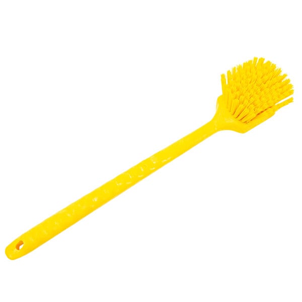 A Carlisle yellow Sparta pot scrub brush with a long handle.