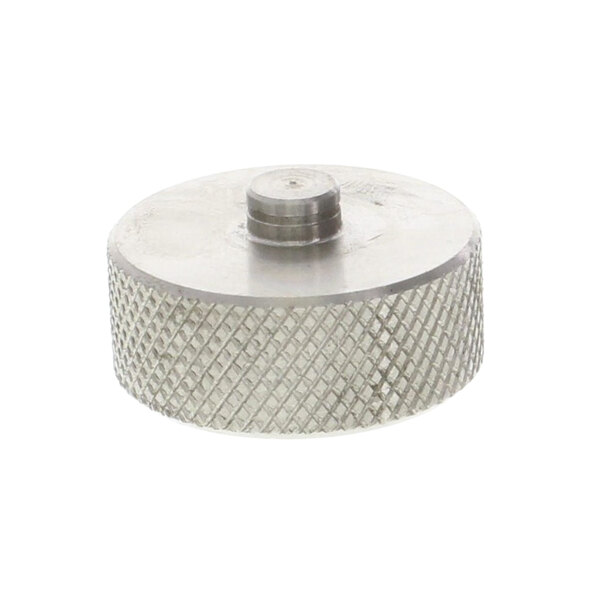 A close-up of a stainless steel metal nut with a metal cap.