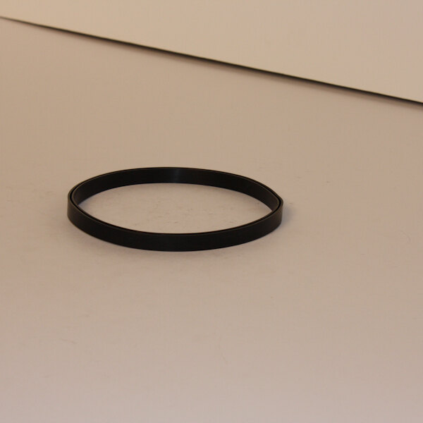 A black rubber cover ring on a white surface.