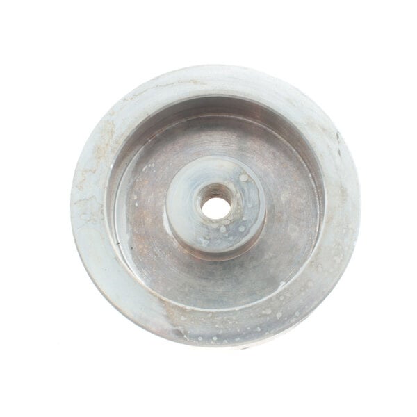 A close-up of a round metal Cleveland bearing housing with a hole in it.